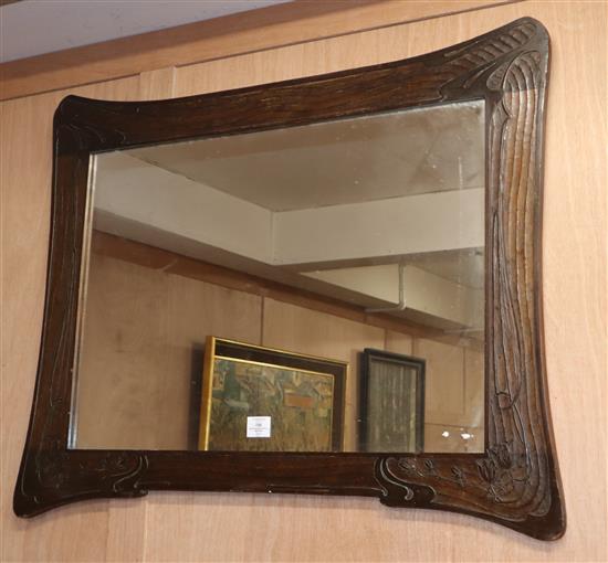 An Art Nouveau carved wood wall mirror W.99cm